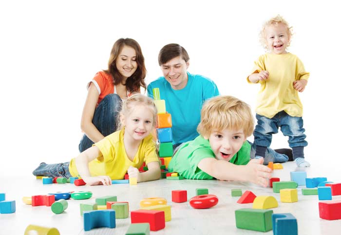 Eltern und Kinder spielen mit Holz Lernspielzeug depositphotos.com
